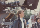 David Lynch squints as he watches the action on the blue screen set.